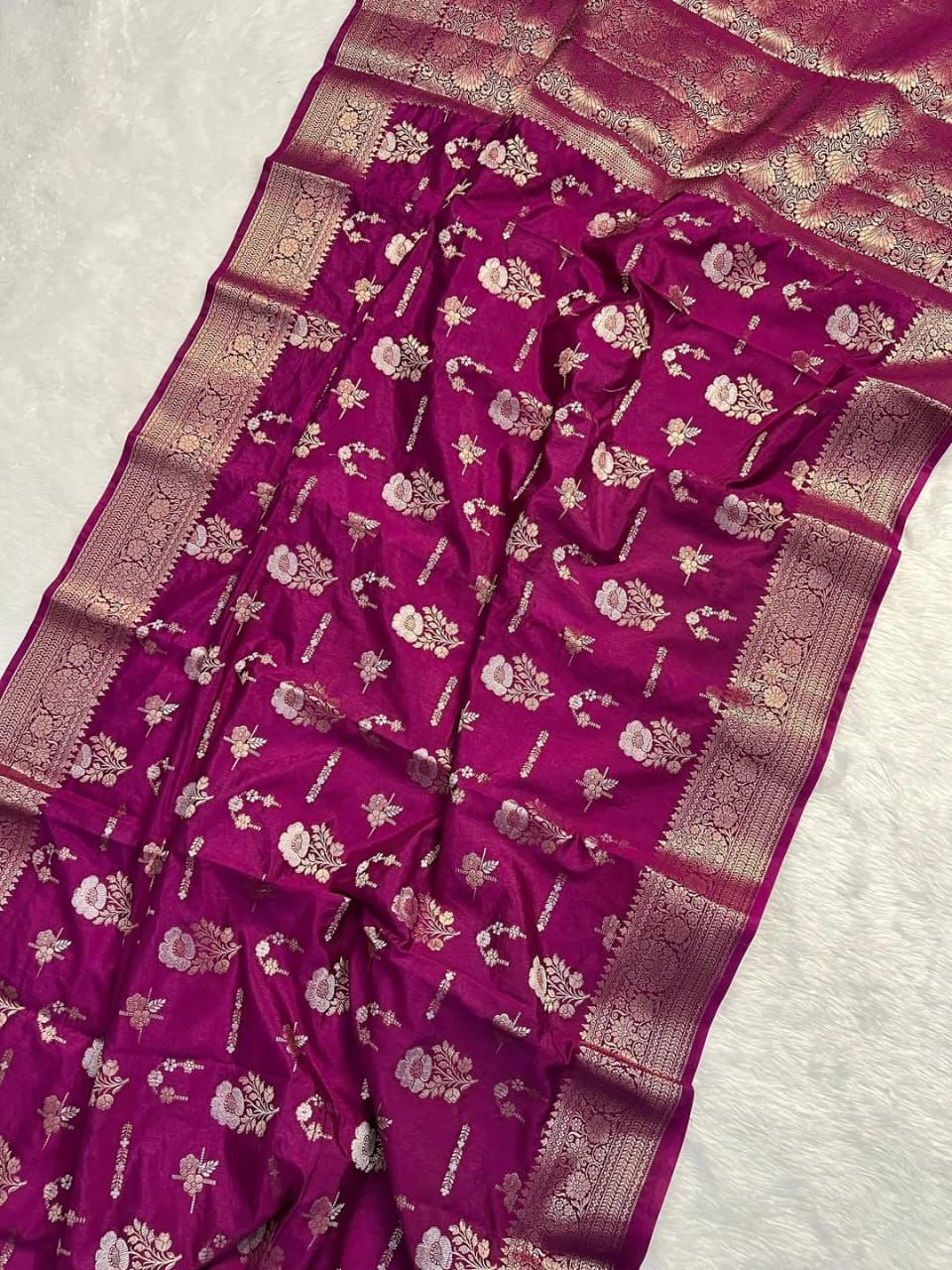 Purple saree with floral patterns on a light gray background