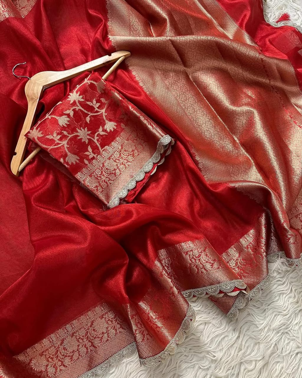 Red fabric with embroidered pocket and hanger on a textured surface