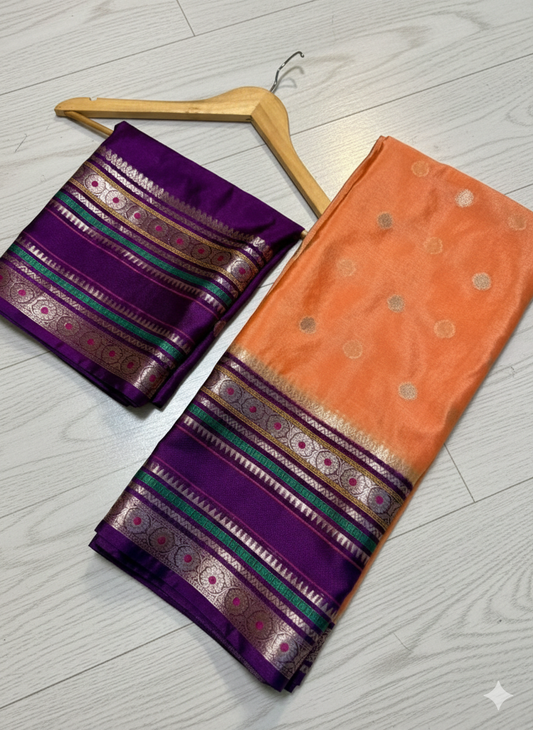 Purple and orange sarees with intricate patterns on a light wooden floor.