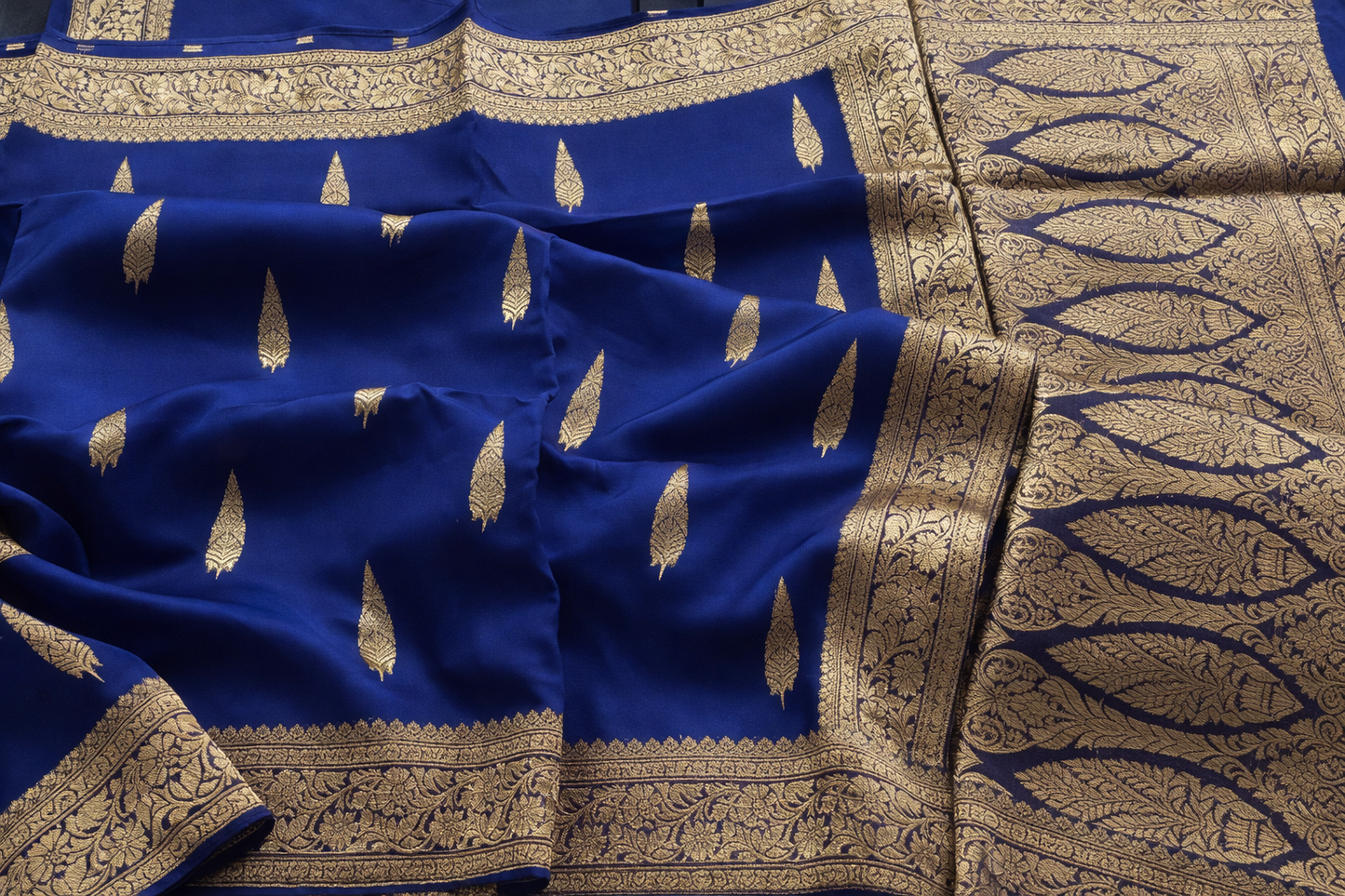 Blue fabric with gold embroidery and patterns