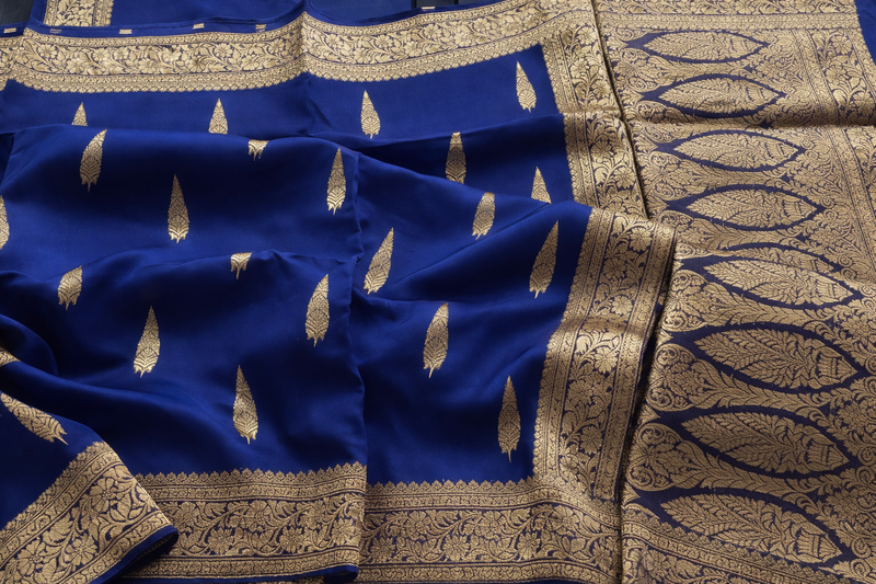 Blue fabric with gold embroidery and patterns
