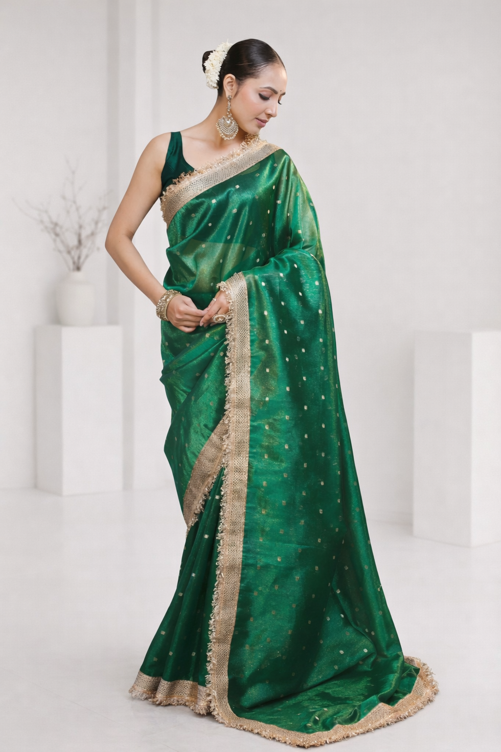 Woman wearing a green saree with a white background