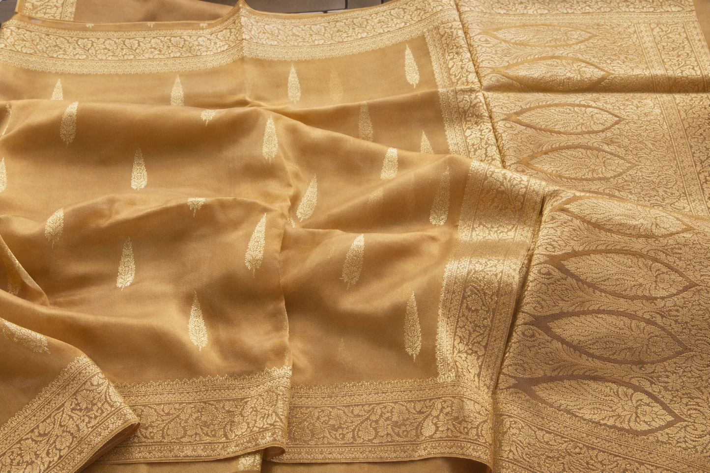 Gold saree with intricate patterns and embroidery