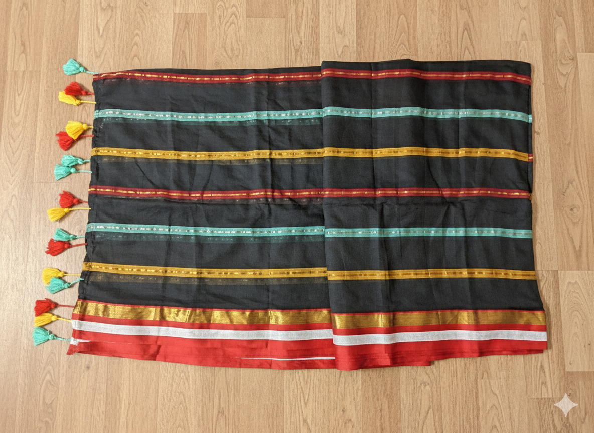 Black fabric with colorful stripes and tassels on a wooden surface