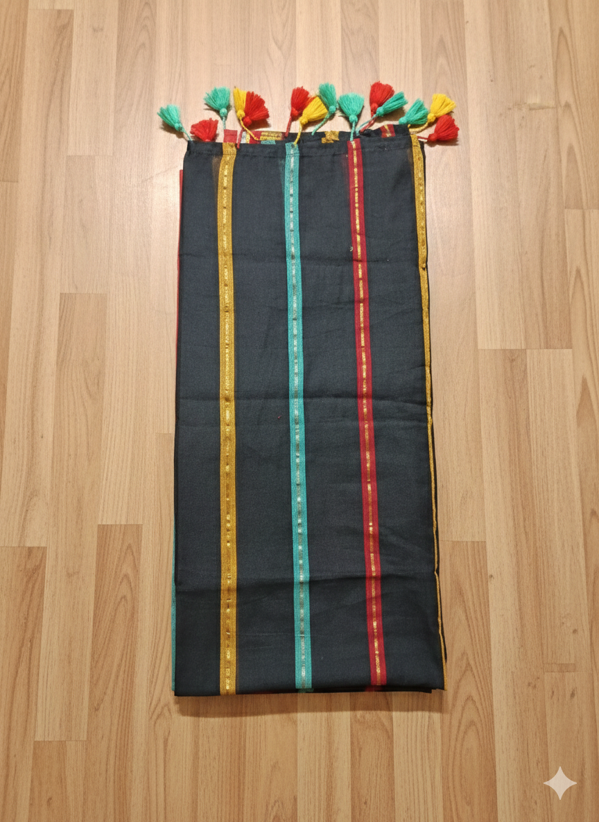 Black fabric with colorful stripes and tassels on a wooden floor