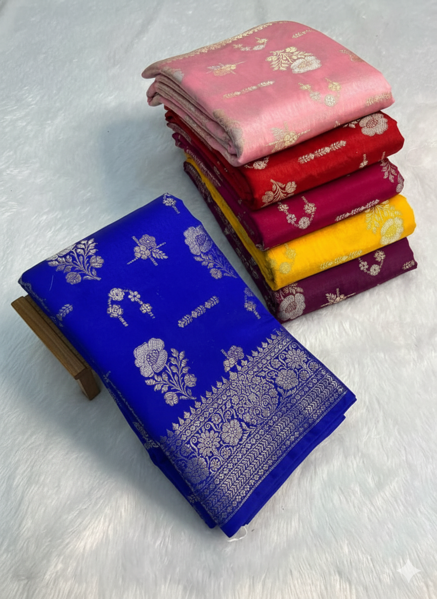 Stack of colorful sarees with a blue saree in front on a light gray background