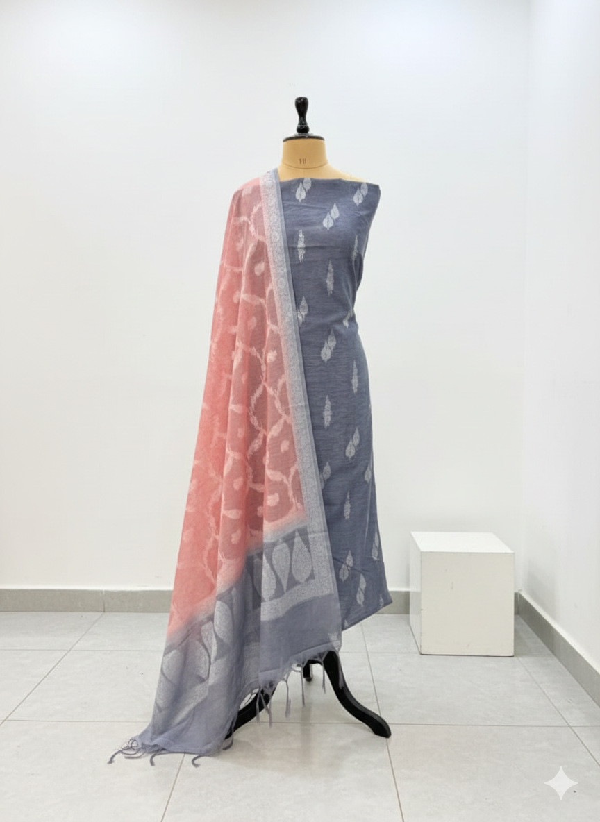 Gray saree with pink border on a mannequin against a white background
