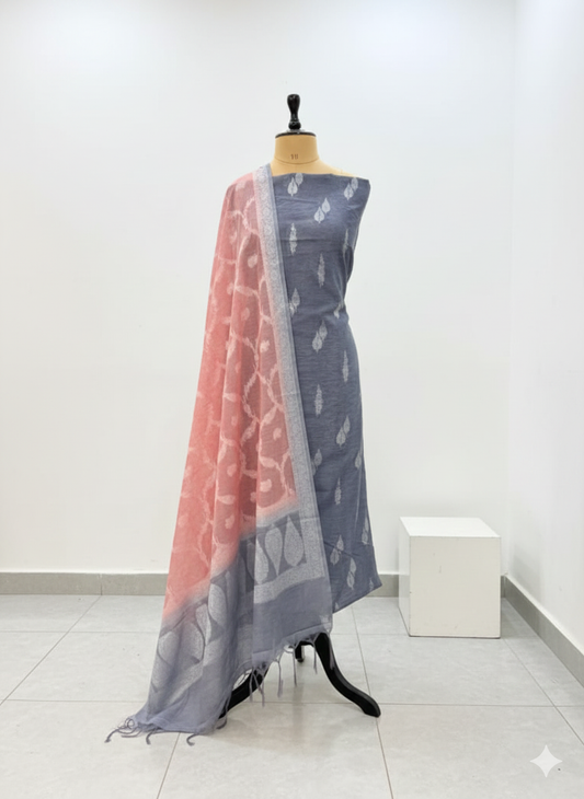 Gray saree with pink border on a mannequin against a white background