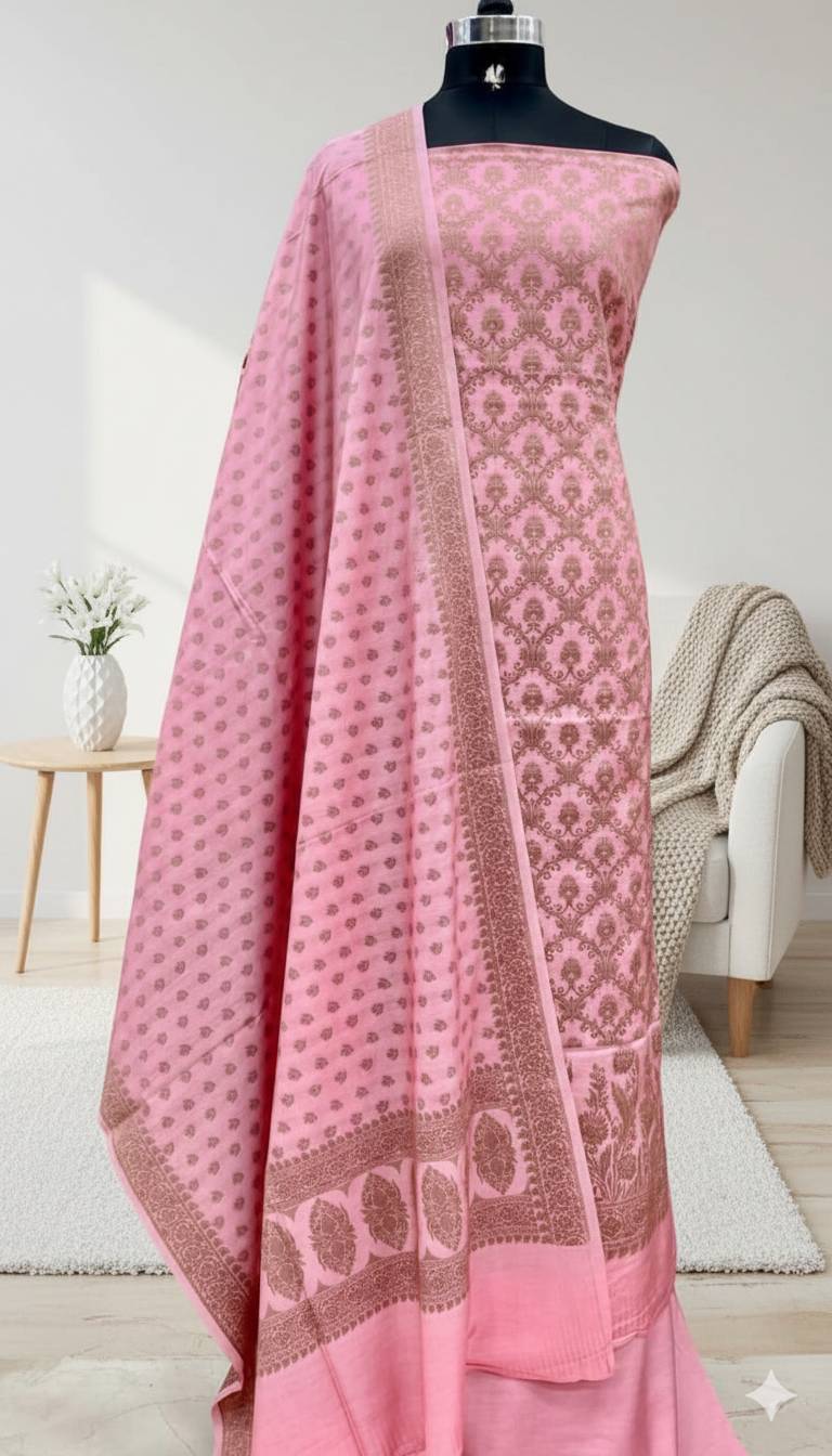 Pink saree with intricate patterns on a mannequin against a neutral background