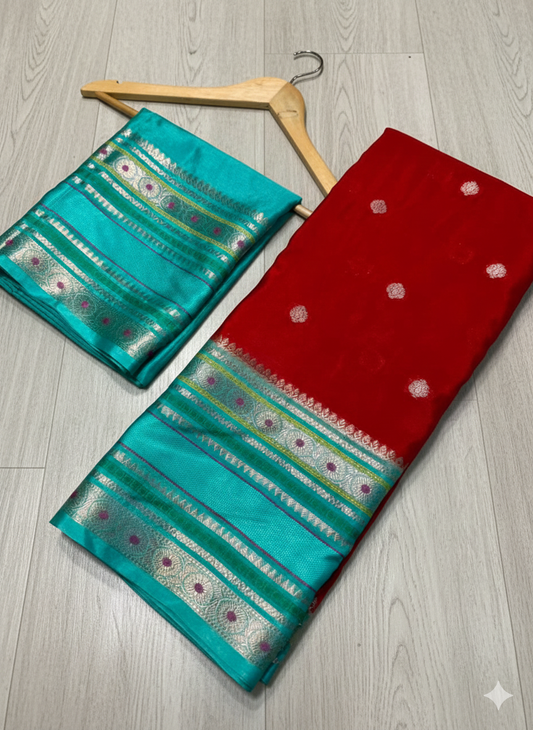 Two sarees, one turquoise and one red with white patterns, on a wooden floor.