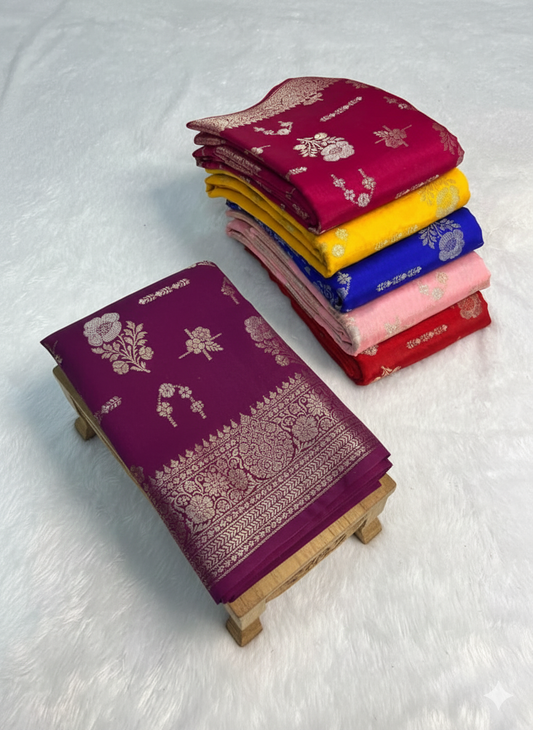 Stack of colorful sarees on a white surface
