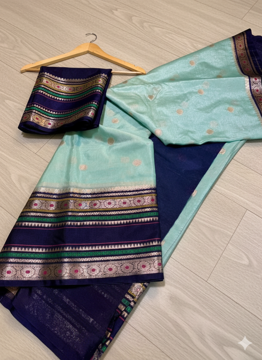 Traditional saree with a blue and green pattern on a wooden floor