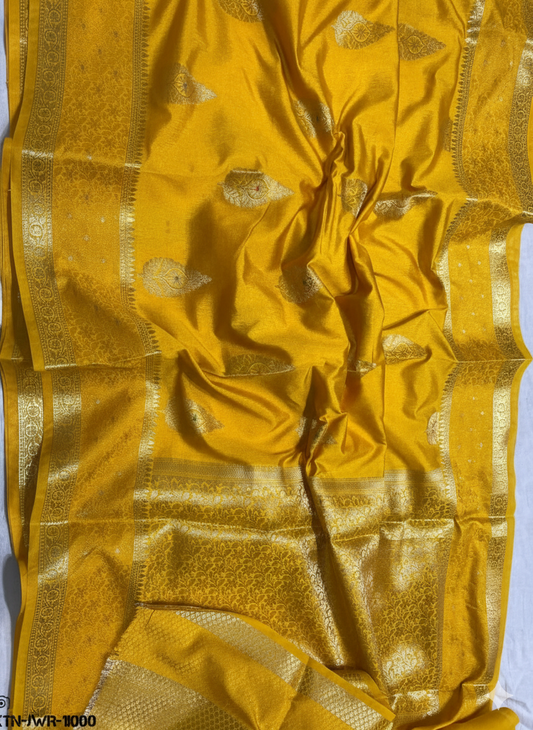 Mustard yellow fabric with gold patterns on a white background