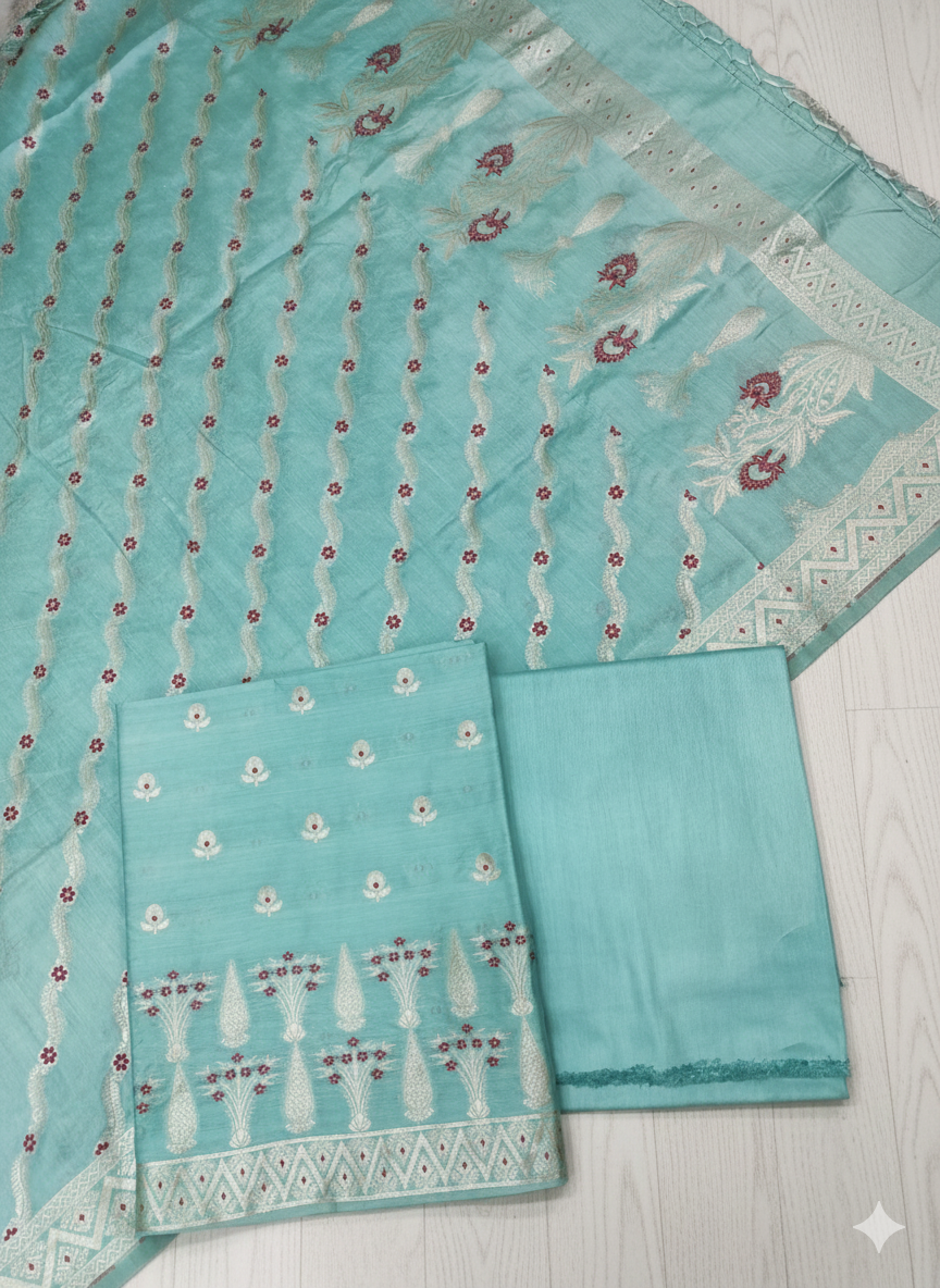 Turquoise fabric with intricate patterns on a light wooden surface