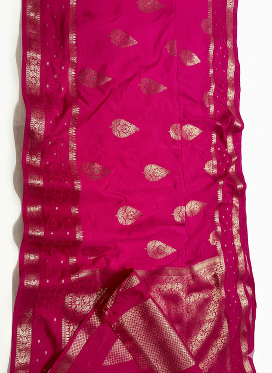 Pink saree with gold patterns on a white background