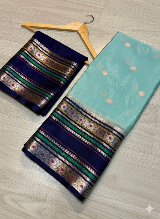 Two sarees with decorative patterns on a wooden surface