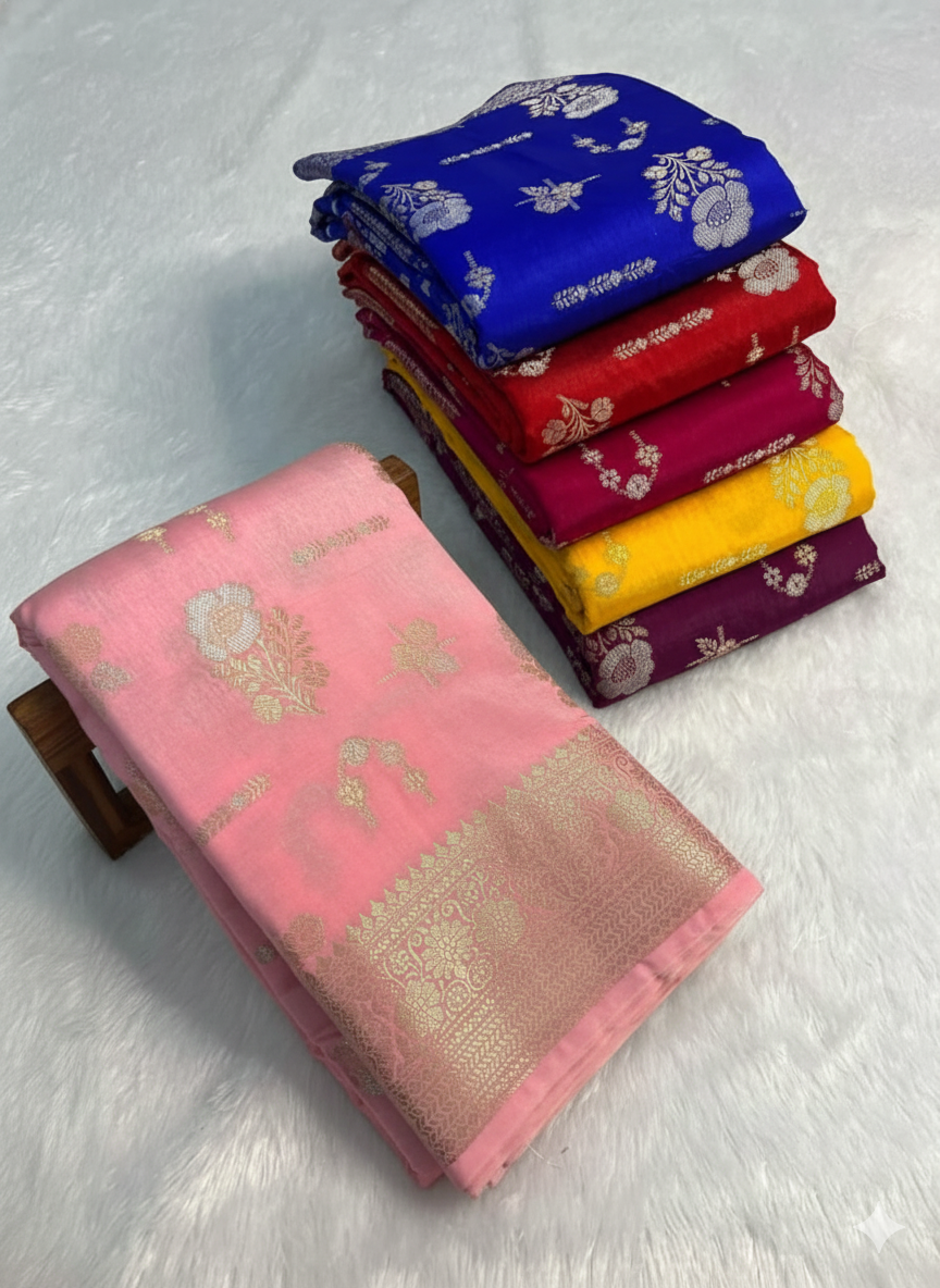 Stack of colorful sarees with a pink saree in front on a light gray background