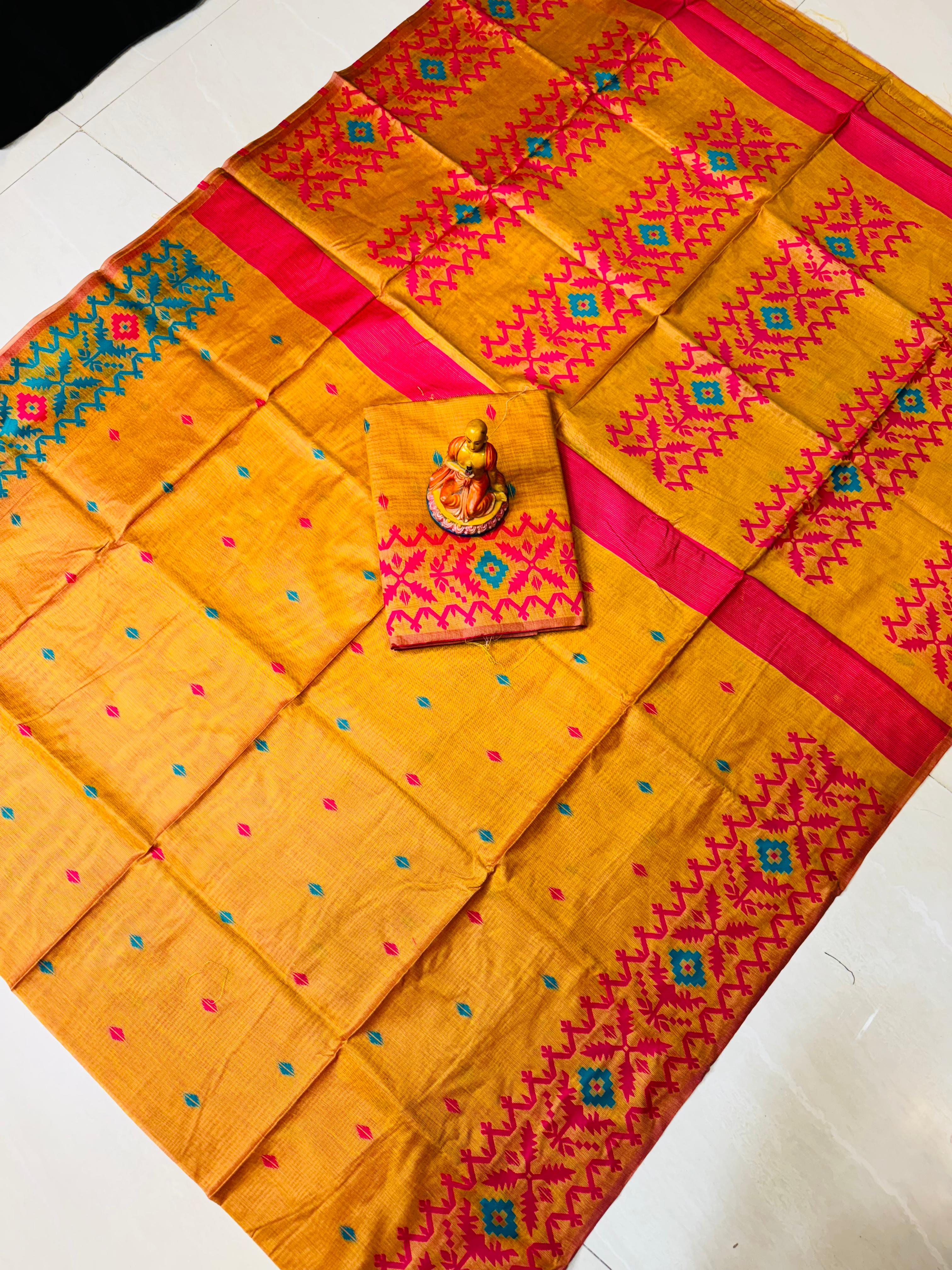 Yellow saree with pink and green patterns on a white background