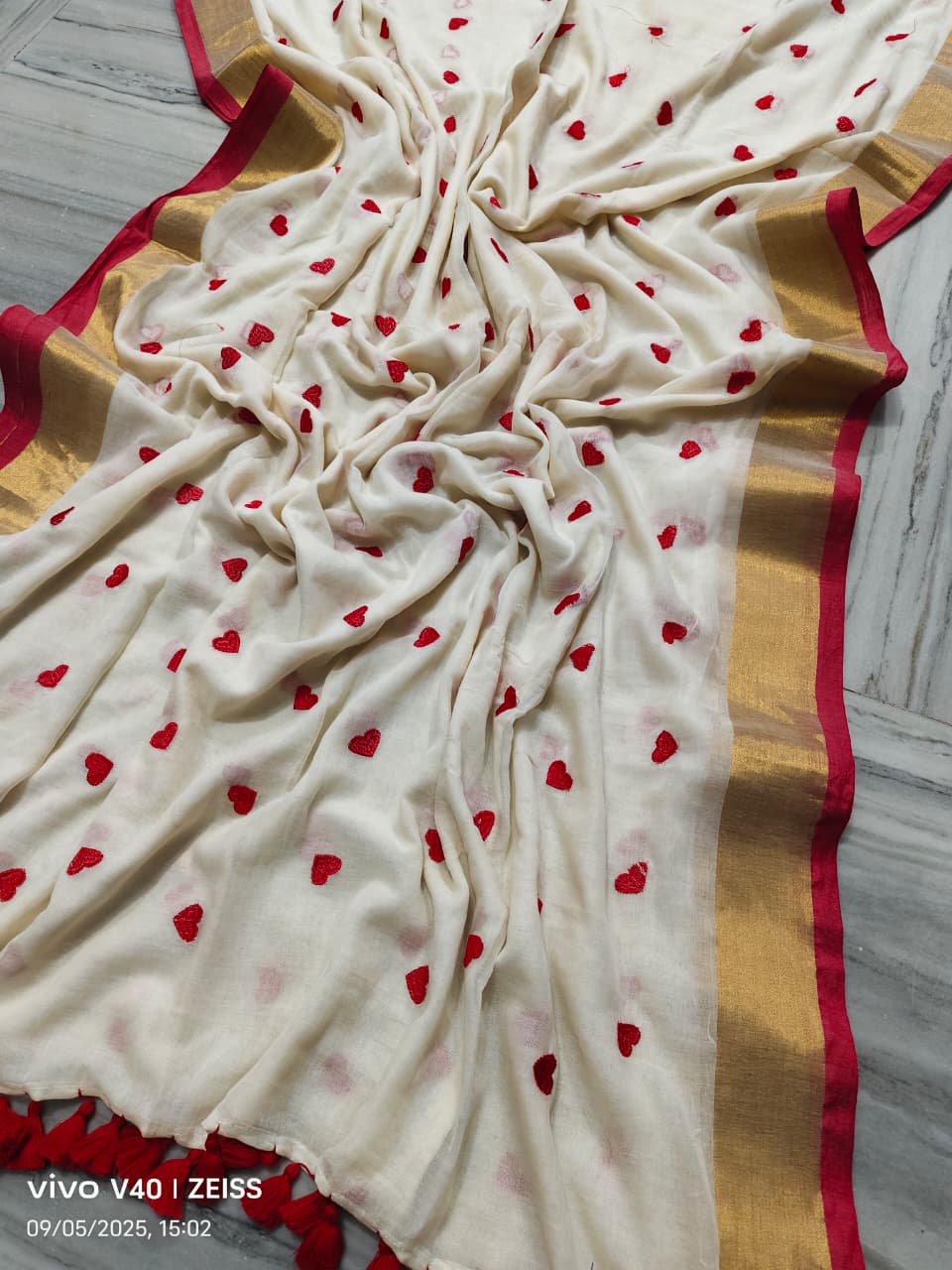 White fabric with red heart patterns on a wooden surface