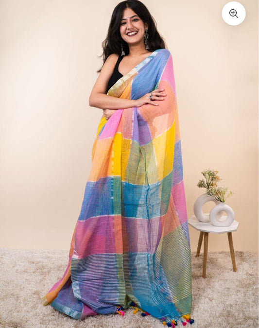 Woman wearing a colorful striped saree with a neutral background