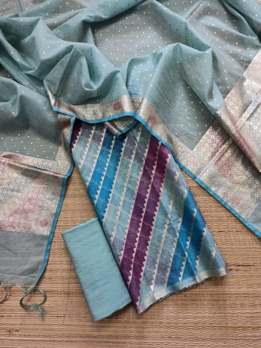 Textile pieces with blue and purple patterns on a wooden surface