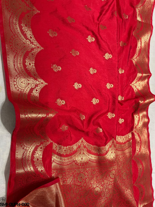 Red fabric with gold embroidery on a white background