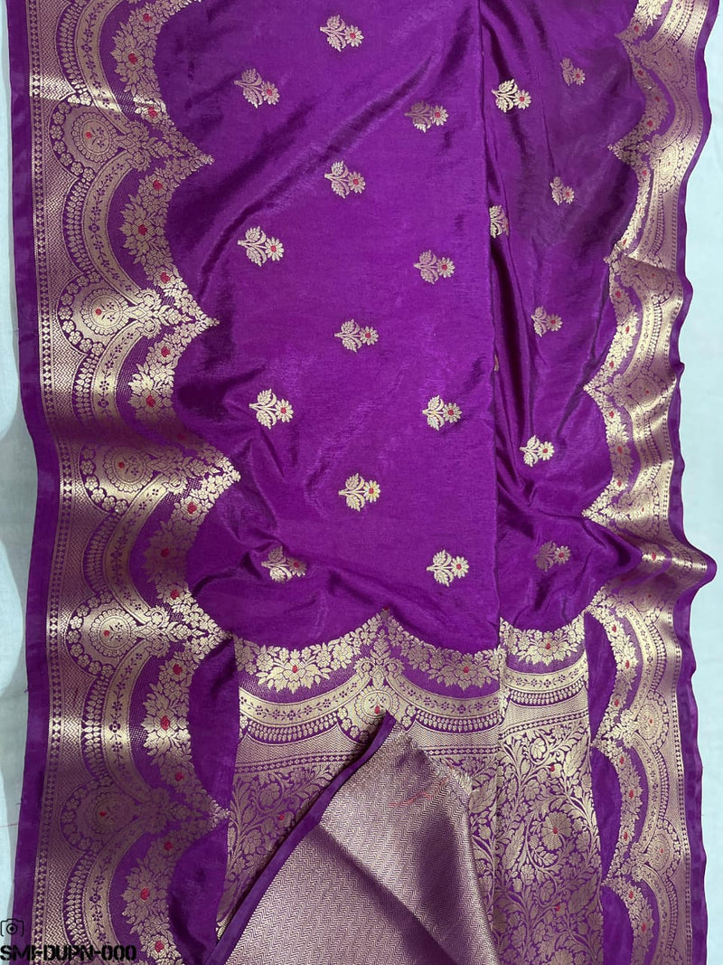 Purple saree with gold and white floral patterns on a light blue background