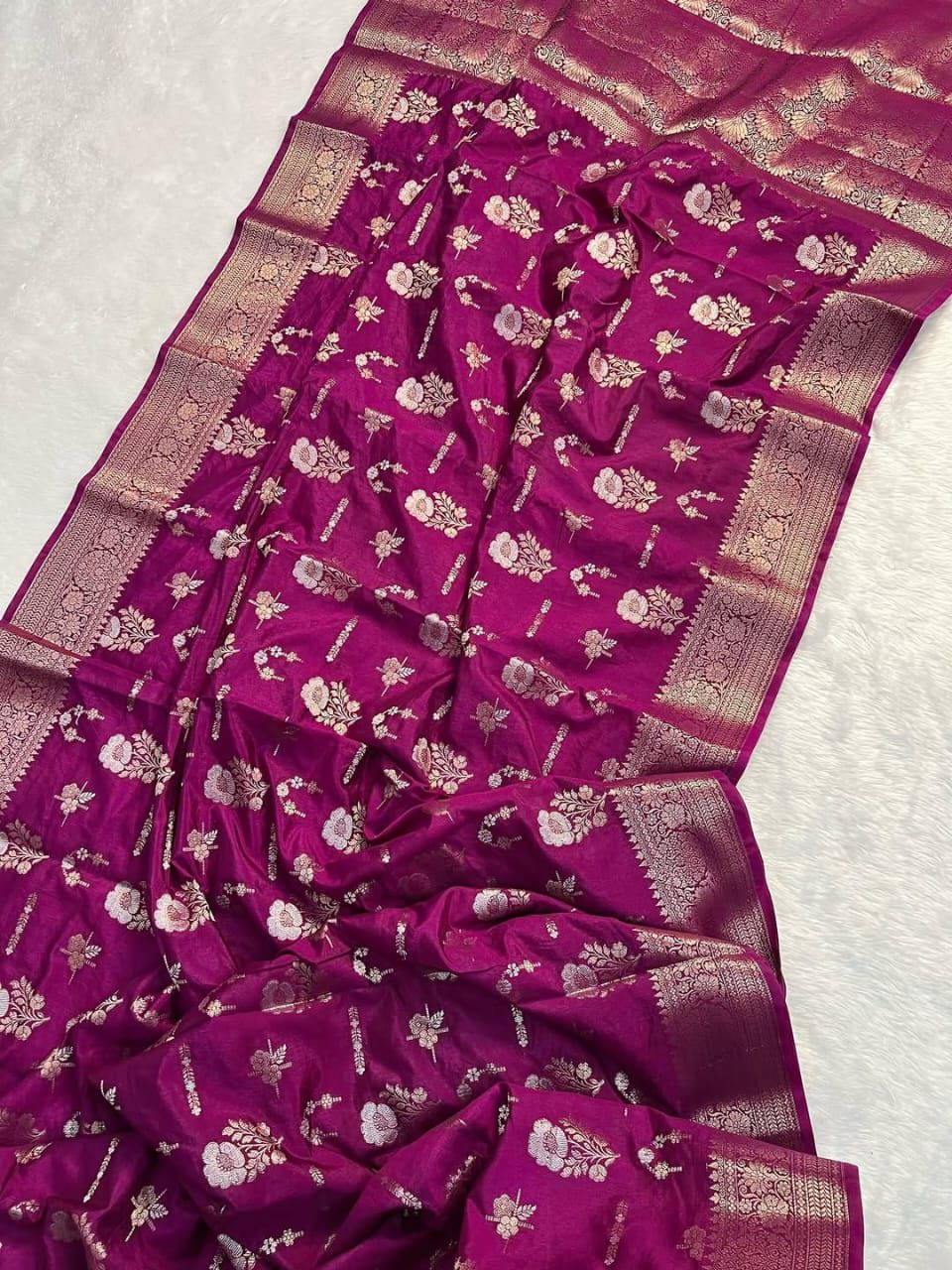 Purple saree with floral patterns on a white background