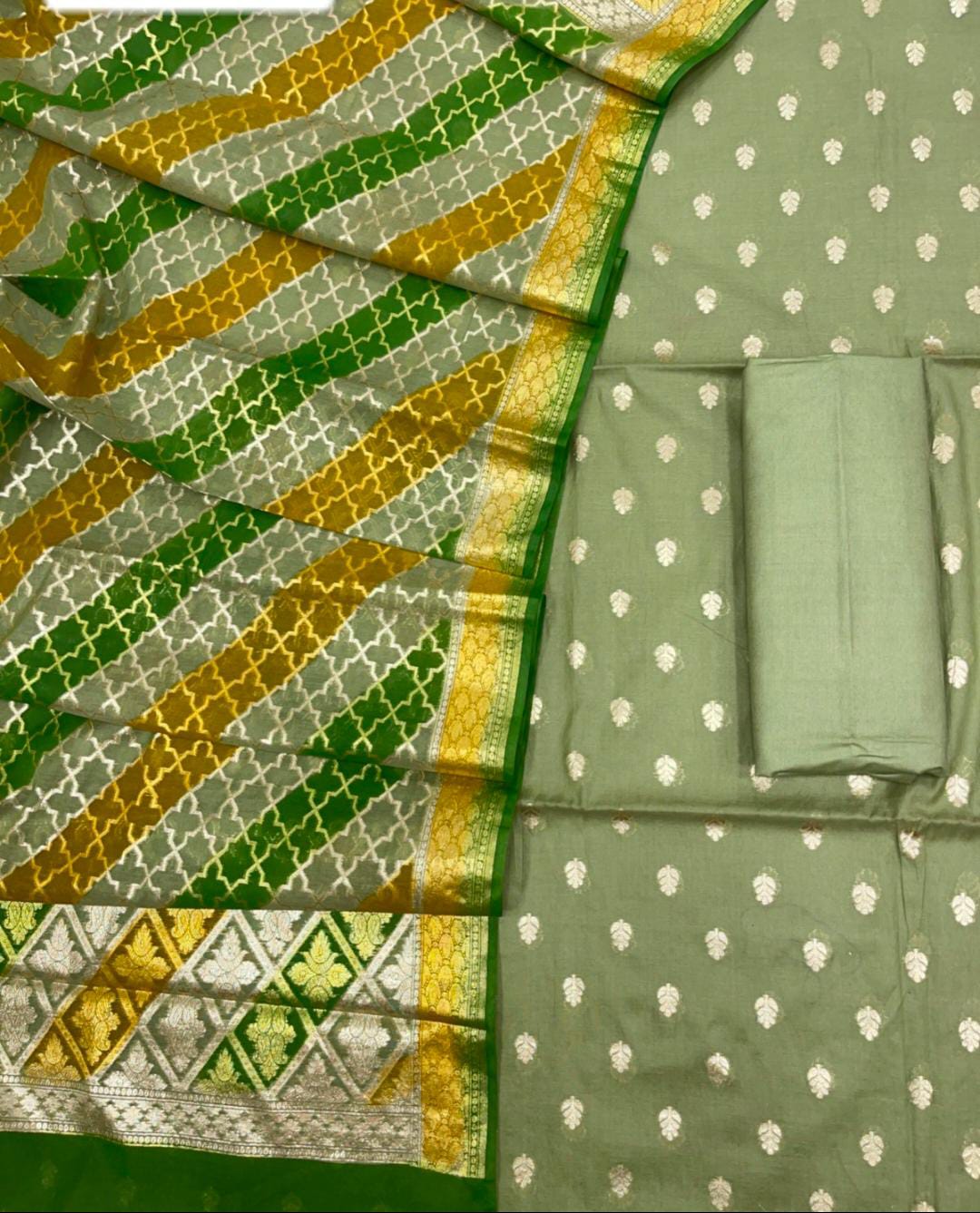 Green and gold patterned fabric with white dot design