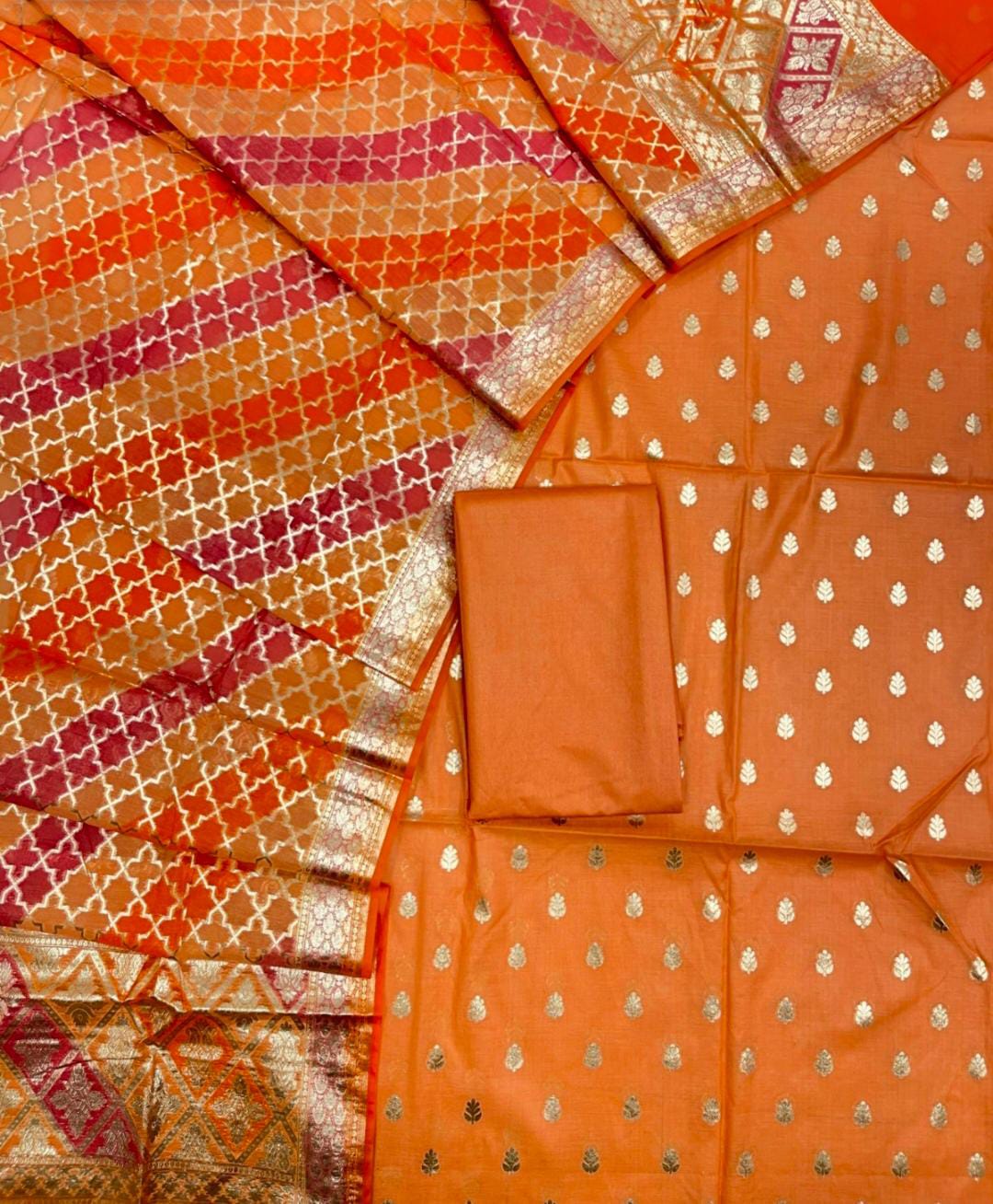 Orange saree with patterned border and white dot design