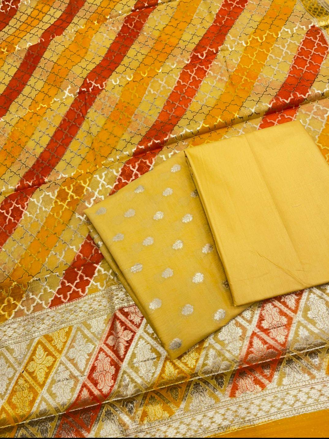 Two yellow fabric pieces on a patterned fabric background