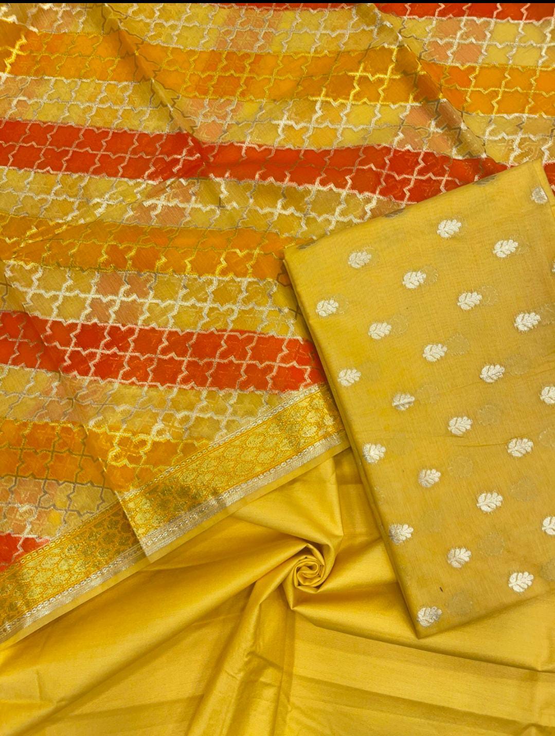 Yellow fabric with various patterns including dots and geometric designs.