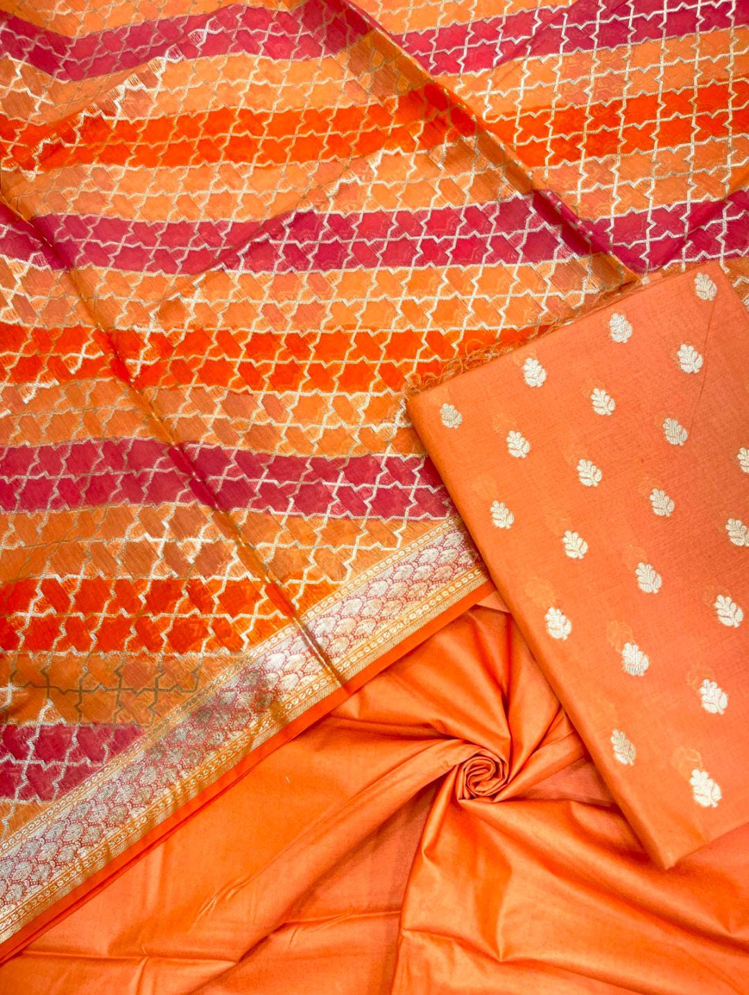 Close-up of orange fabric with intricate patterns