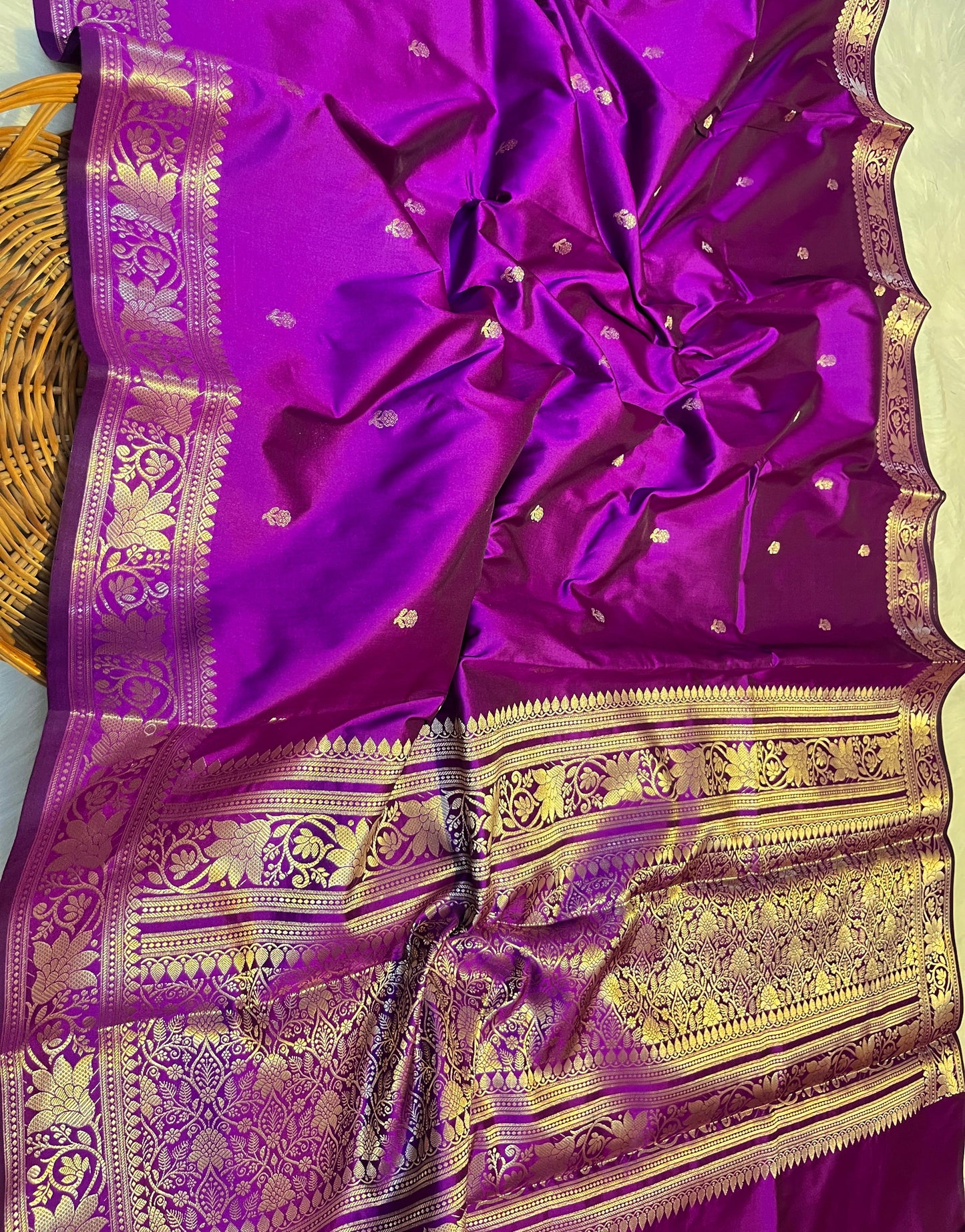 Purple saree with gold patterns on a white background