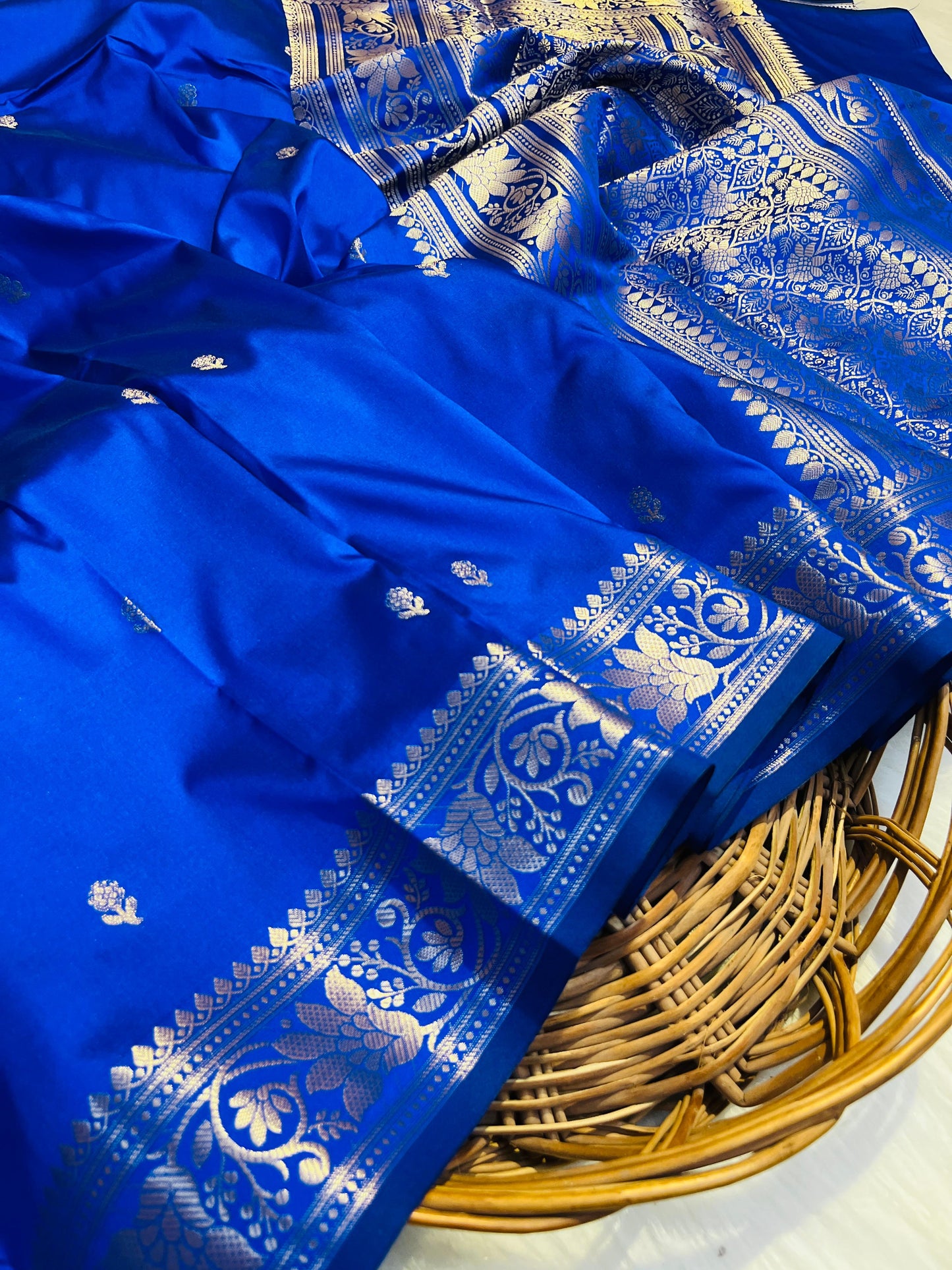 Blue saree with white patterns on a woven basket