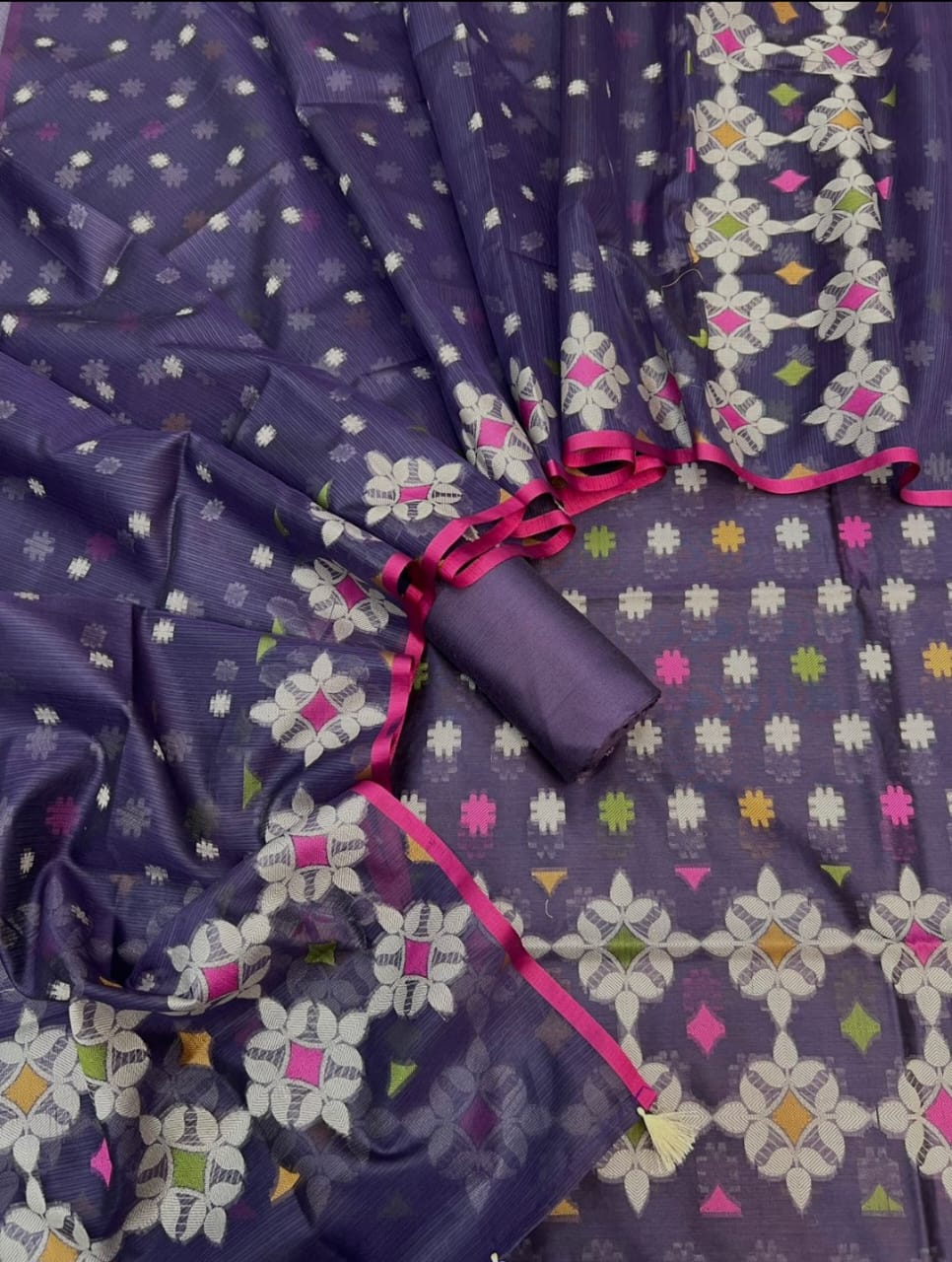 Purple fabric with colorful geometric pattern and pink accents