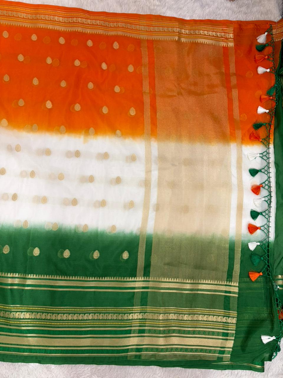 Traditional saree with orange, white, and green stripes on a white background
