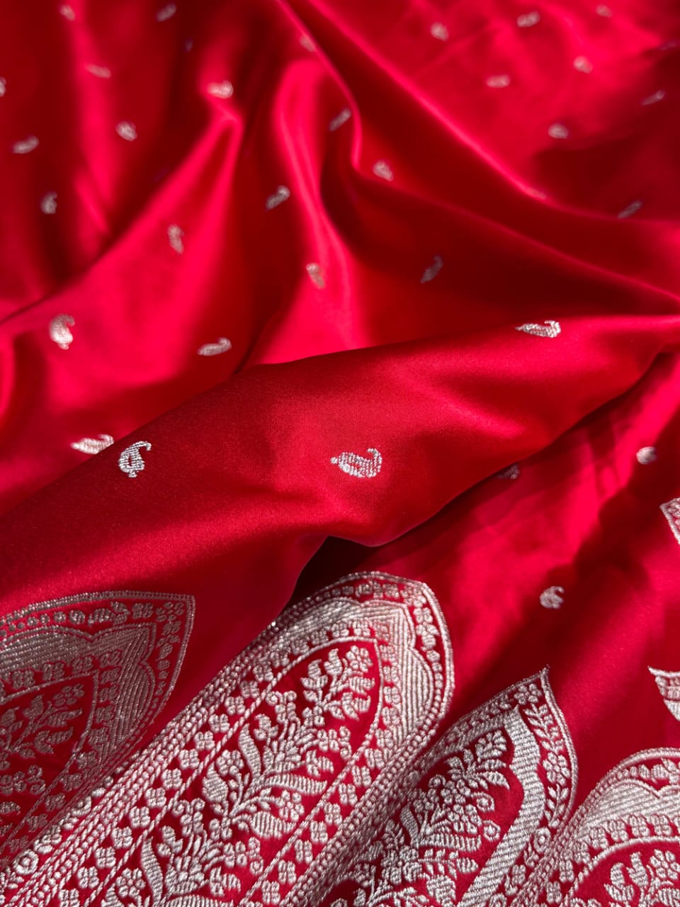 Close-up of red fabric with white paisley patterns