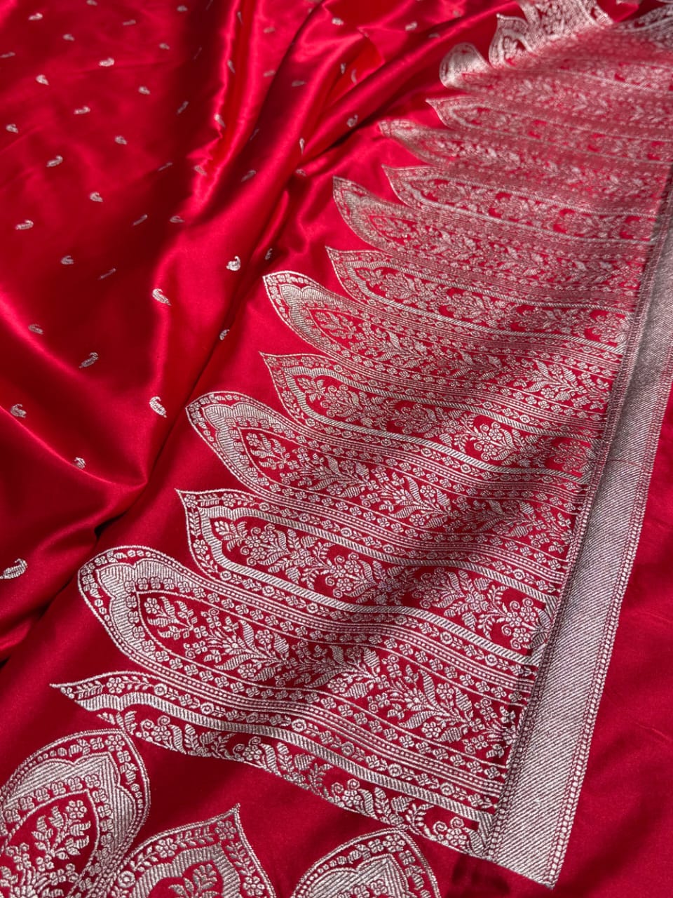 Red fabric with intricate white patterns