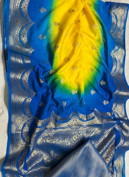 Blue and yellow saree with intricate patterns on a white background