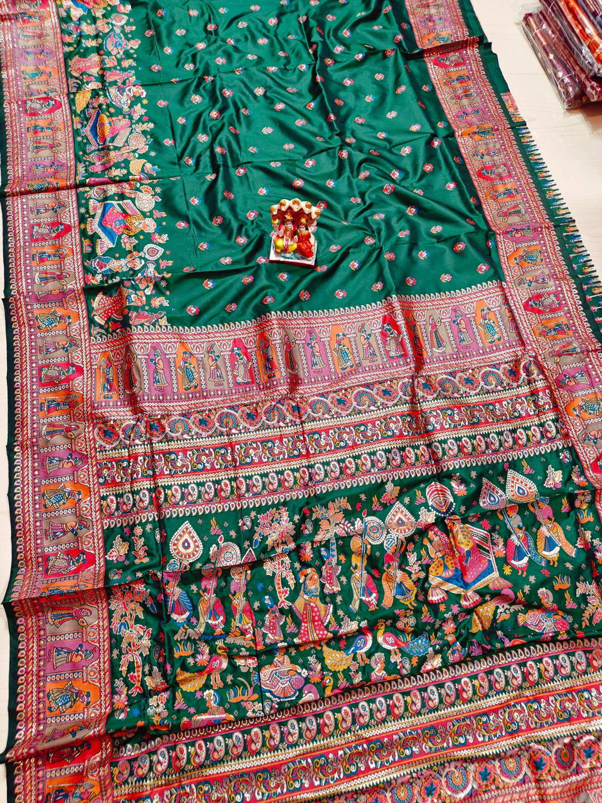 Colorful traditional fabric with intricate patterns on a white background