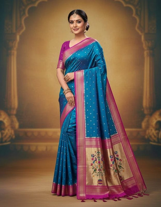 Woman wearing a blue and pink saree with a decorative background