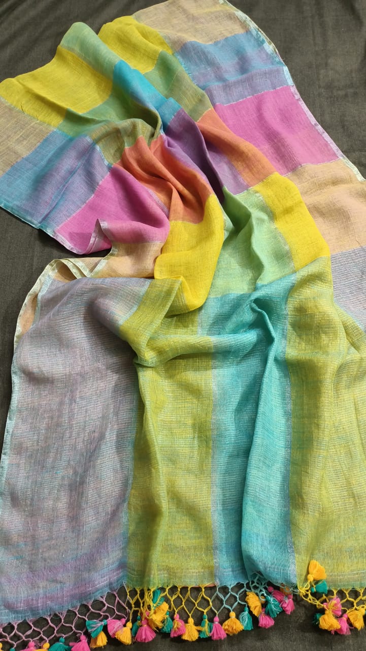 Colorful fabric with tassels on a plain background
