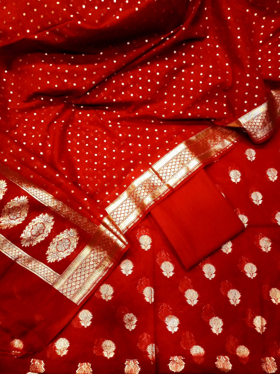 Red fabric with white patterns and gold accents