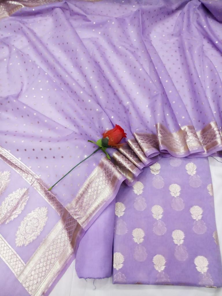 Purple fabric with silver embroidery and a red rose on a white background