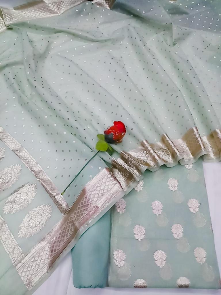 Light blue fabric with white patterns and a red flower on a white background