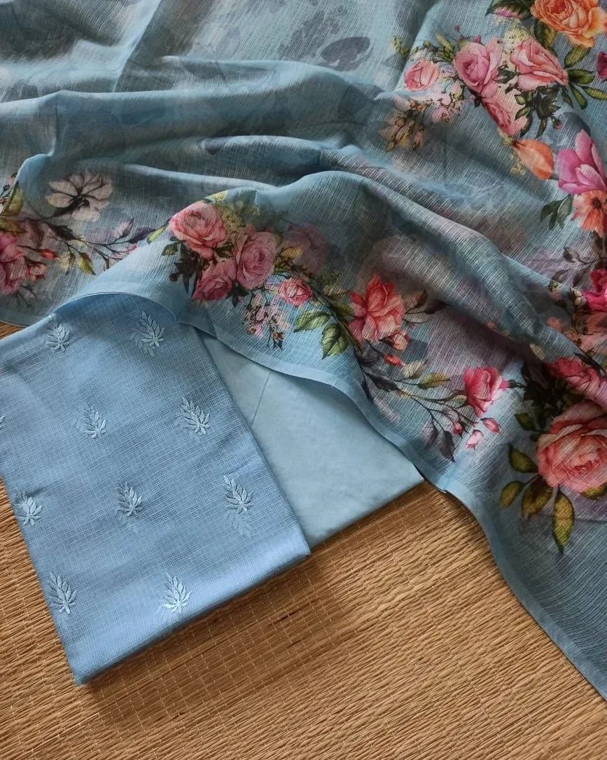 Floral fabric and embroidered fabric on a wooden surface