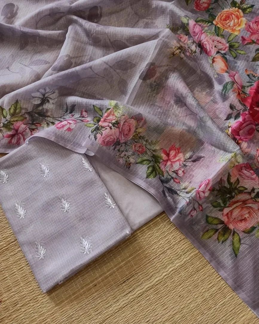 Floral fabric with embroidered details on a wooden surface