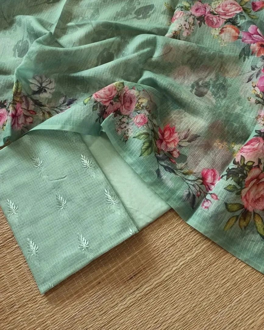 Green fabric with floral patterns on a wooden surface