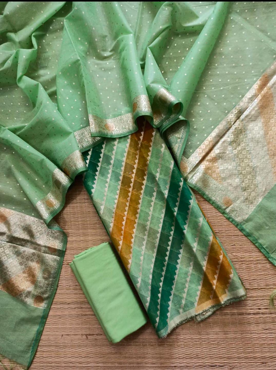 Green fabric with patterns on a wooden surface